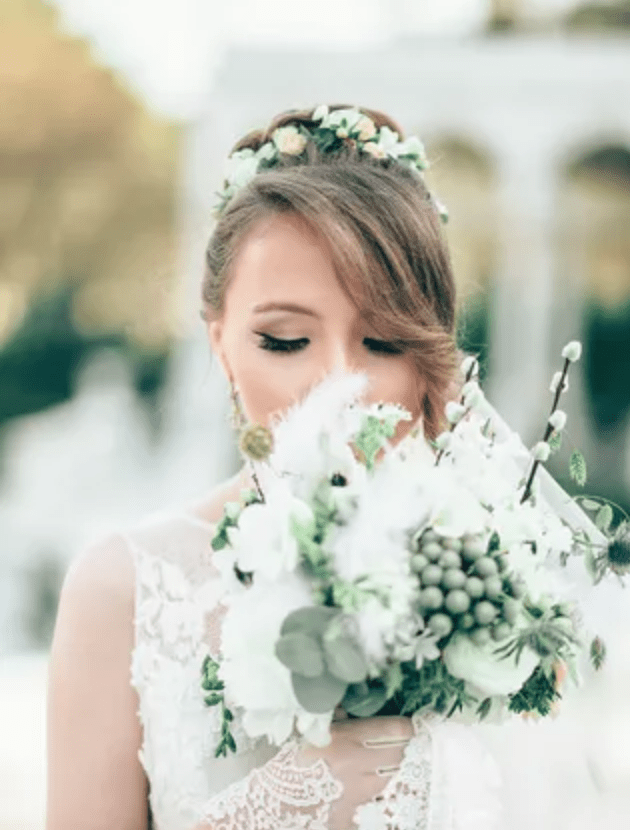 Bride smelling bouquet